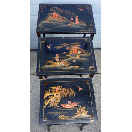 765 - A nest of three black painted, Oriental style nest of tables