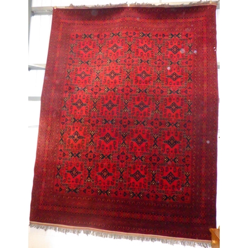 780 - A large red ground Afghan carpet