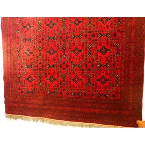 780 - A large red ground Afghan carpet