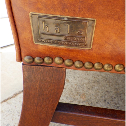 785 - A brown leather wingback armchair, mark to back, with label Halo