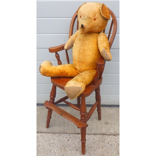 821 - A reproduction Windsor child's chair together with a large jointed teddy bear, worn (2)