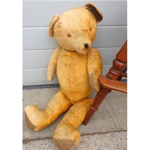 821 - A reproduction Windsor child's chair together with a large jointed teddy bear, worn (2)