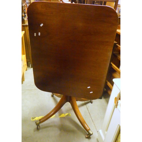 841 - A mahogany tilt top table, castor a/f, 84cm across, together with a suitcase (2)