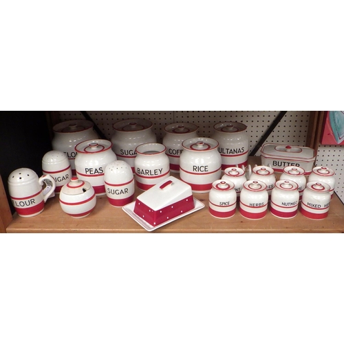 103 - A collection of Sadler Kleen Kitchen Ware storage jars and kitchen pottery, having red painted band ... 