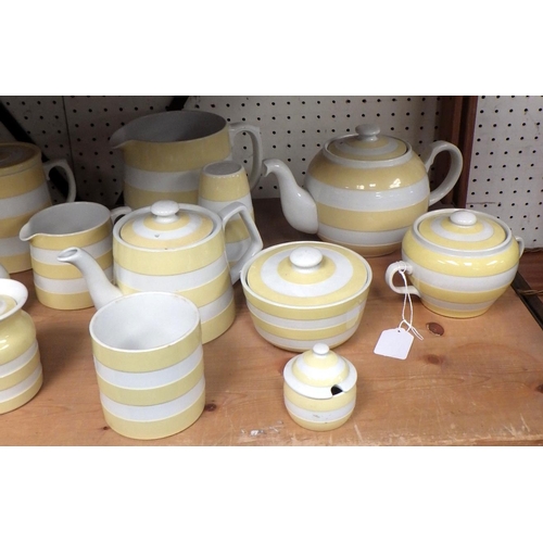 104 - A collection of T G Green Cornish Kitchen Ware yellow detail storage jars and kitchenware. A/F