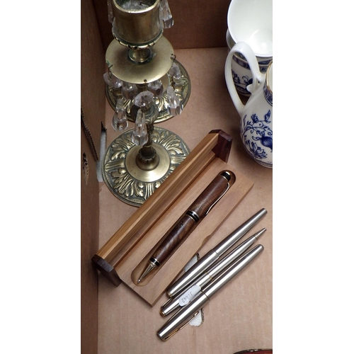 132 - Three decanters, a bone china tea set, a pair of candlesticks, pens etc.