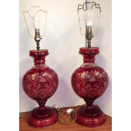 100 - A pair of red-flashed-glass vase-based table lamps with pleated shades.