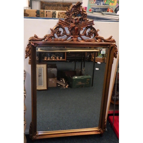 106 - A wall mirror within a composite gilt frame, 123cm tall; a reproduction fretwork wall mirror; a pain... 