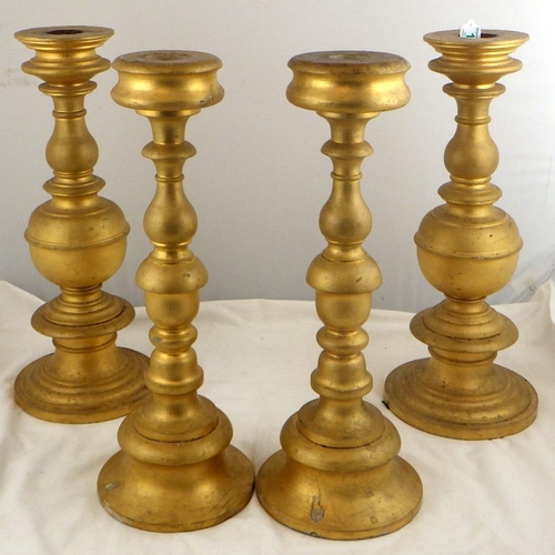 135 - Two pairs of gilt turned wood candlesticks, 42.5cm tall.  Ex. York Minster Stores