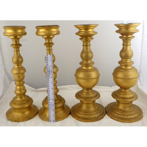 135 - Two pairs of gilt turned wood candlesticks, 42.5cm tall.  Ex. York Minster Stores
