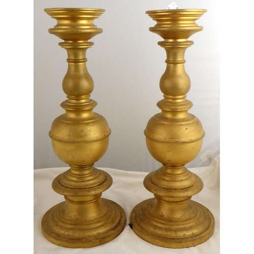 135 - Two pairs of gilt turned wood candlesticks, 42.5cm tall.  Ex. York Minster Stores