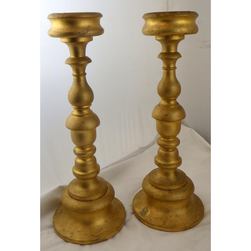 135 - Two pairs of gilt turned wood candlesticks, 42.5cm tall.  Ex. York Minster Stores