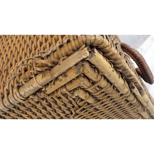 141 - A wicker storage basket having brass hinges and lock hasp.