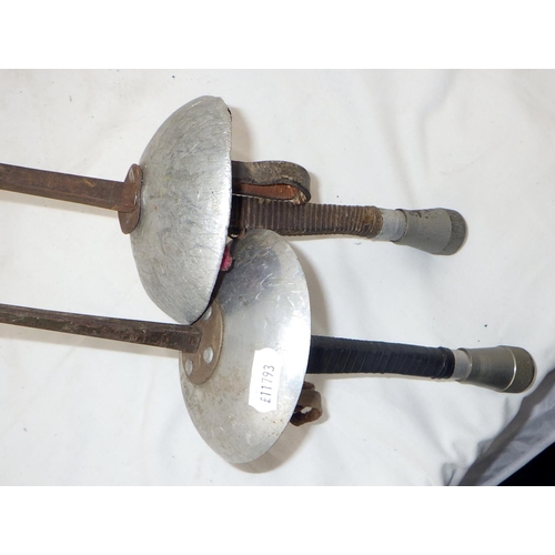 143 - A pair of fencing rapiers together with two fencing foils. (4)