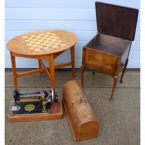 643 - An inlaid oak chess board top occasional table together with a Singer sewing machine and a sewing bo... 