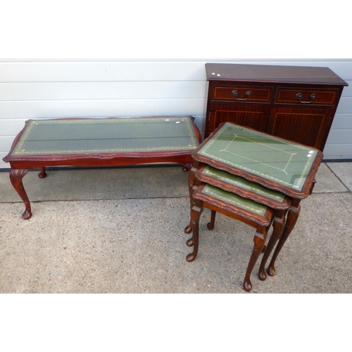 650 - A leather top nest of three tables together with matching coffee table and a mahogany cupboard (3)