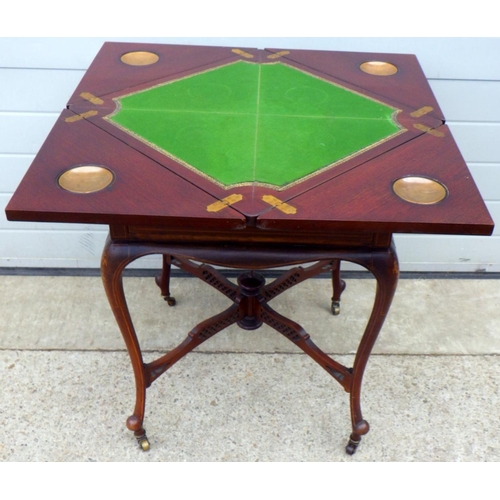 665 - A late Victorian mahogany inlaid envelope card table