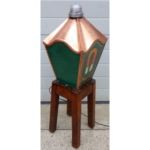 667 - A John Smith's lamp top attached to a stool base