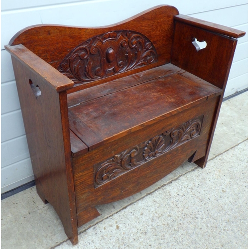 672 - An Art Nouveau carved oak hall seat 78cm wide