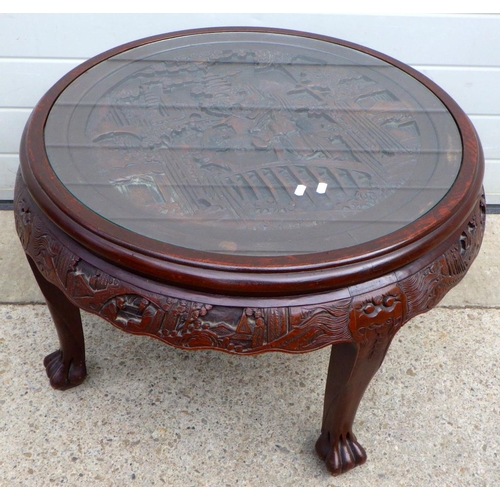 673 - A circular Oriental carved coffee table 80cm diameter