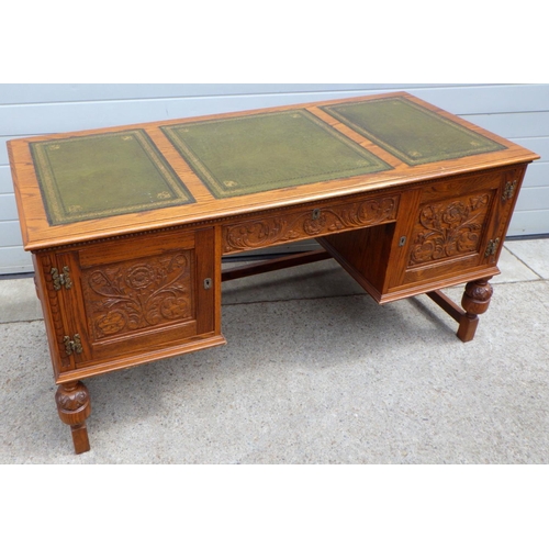 681 - A Jaycee carved oak leather top desk