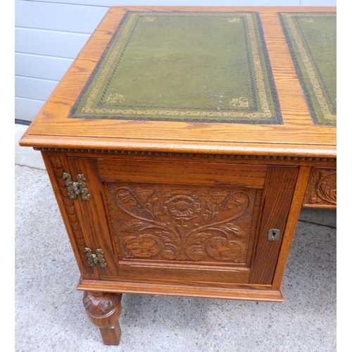 681 - A Jaycee carved oak leather top desk