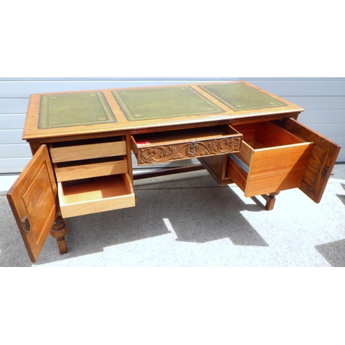 681 - A Jaycee carved oak leather top desk