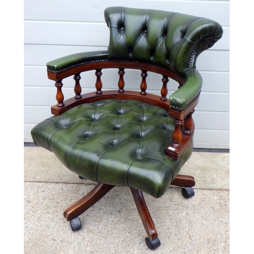 684 - A mahogany button back green leather captains desk chair