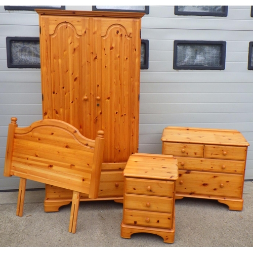 774 - A pine Ducal bedroom suite to include wardrobe, chest, bedside chest and a single bed head (4)