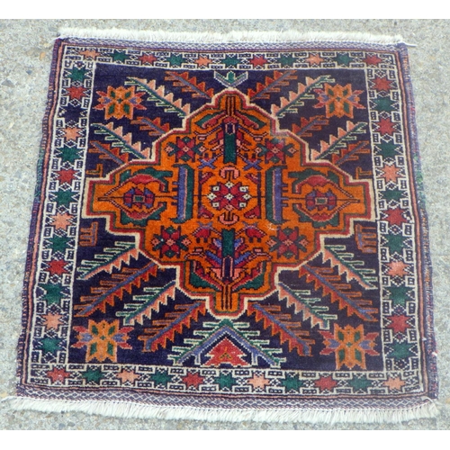 810 - A small square rug 60 x 60cm