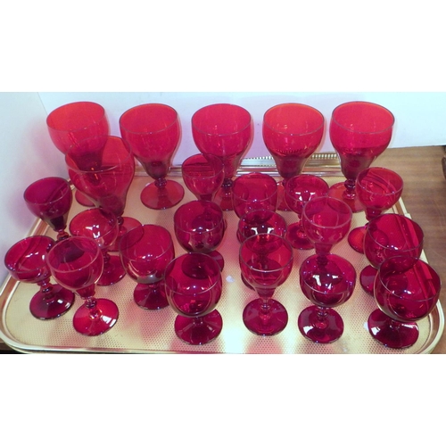 153 - A collection of red glass incl decanters and drinking glasses; two glass table lamp bases. (2)