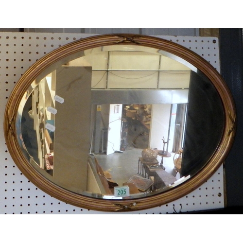 205 - A gilt framed wall mirror.  Approximately 60 x 46cm oval.