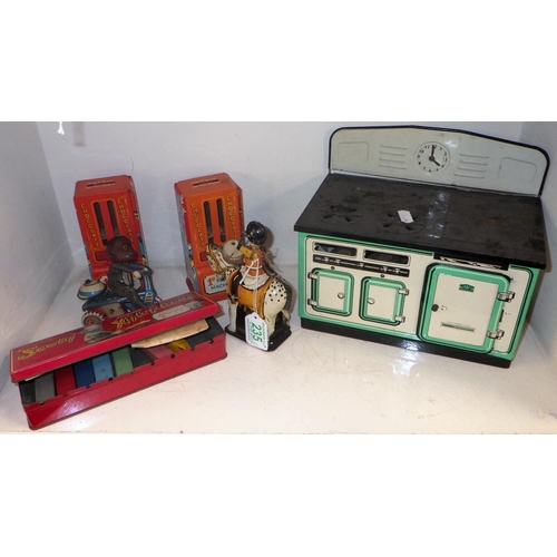 235 - A Mettoy tinplate toy range oven, other tinplate incl Sooty interest and toy chocolate dispensers.  ... 