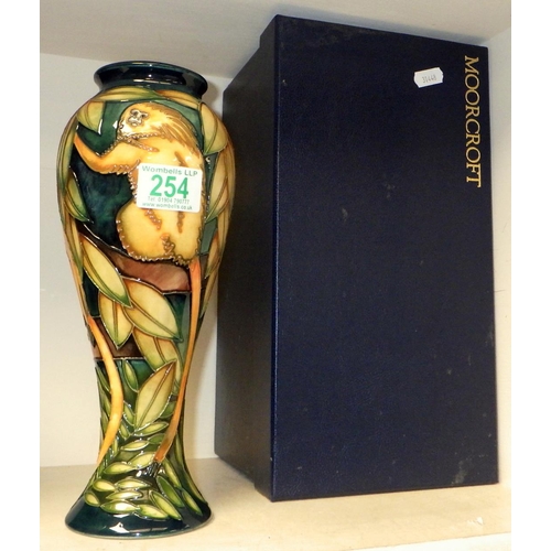 254 - A Moorcroft Pottery vase the decoration depicting monkeys in foliage, boxed.