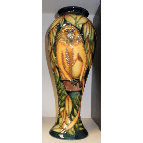 254 - A Moorcroft Pottery vase the decoration depicting monkeys in foliage, boxed.