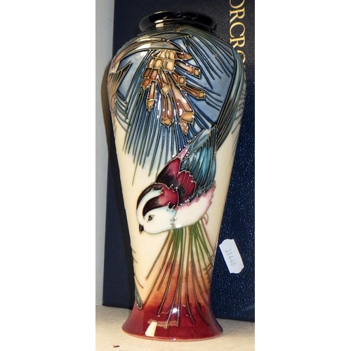 255 - A Moorcroft Pottery vase, the design depicting a robin and other birds, boxed.