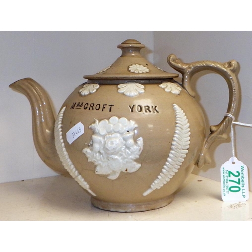 270 - A teapot in drabware stoneware having sprig decoration and bearing impressed wording 