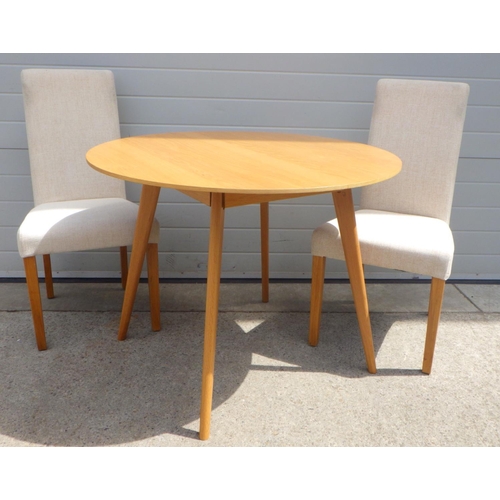 840 - A circular dining table and two chairs (3)