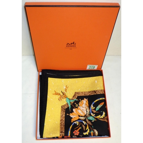 319 - A Hermes Paris silk scarf - flower and bird motif design on a black ground within a gold border.  Bo... 