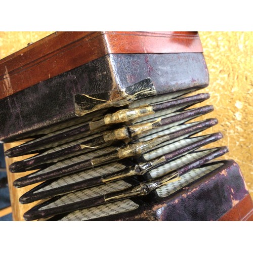 271 - A concertina.  A/F old restoration, lacking name plate.  Cased.