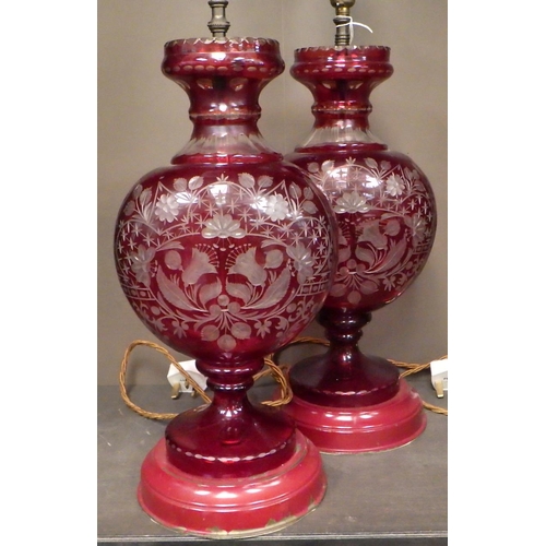156 - A pair of red-flashed-glass vase-based table lamps with pleated shades.