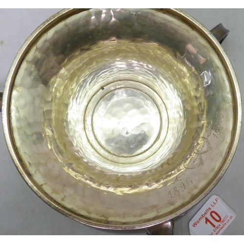 10 - An Arts & Crafts silver three handled pedestal bowl, William Hutton & Sons Ltd, Sheffield 1910.  177... 