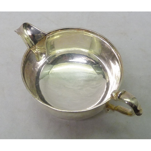 14 - An Art Deco silver jug having planished finish, C Shapland & Co, London 1934.  160mm long / 260g