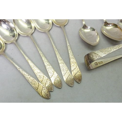 29 - A part set of eleven Edwardian silver teaspoons with matching tongs, Glasgow 1907, cased; a pair of ... 