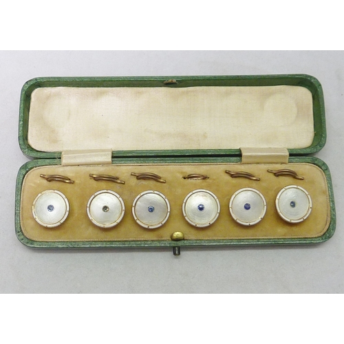 38 - A cased set of six dress waistcoat buttons, mother of pearl and enamel with blue stone set centres o... 