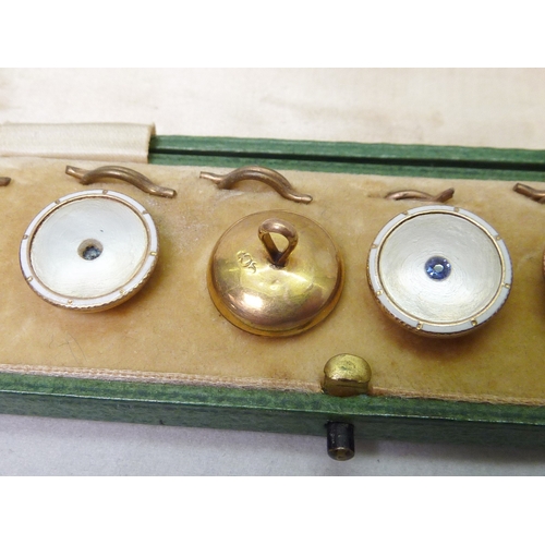 38 - A cased set of six dress waistcoat buttons, mother of pearl and enamel with blue stone set centres o... 