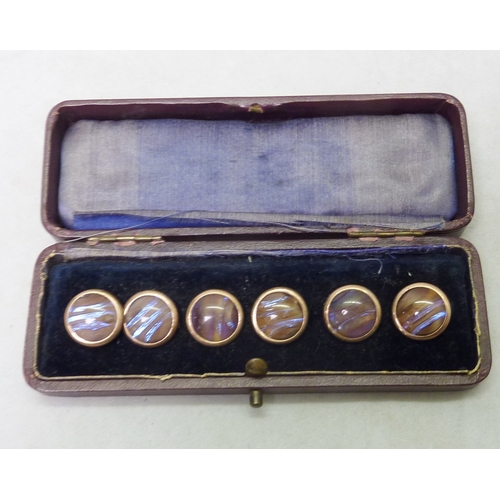 39 - A cased set of six mother of pearl fronted dress waistcoat studs with stone set centres, unmarked ye... 