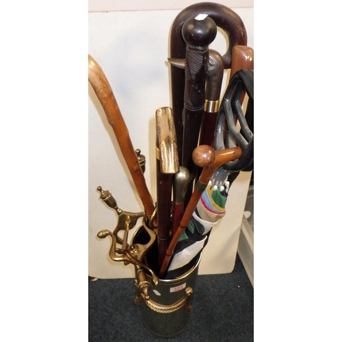 322 - A brass stick stand and sticks together with brass fire dogs etc