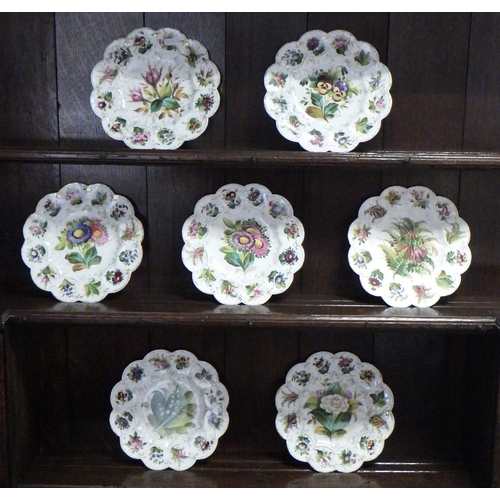 375 - A group of seven matching floral decorated plates.