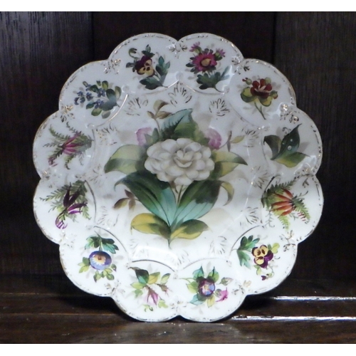 375 - A group of seven matching floral decorated plates.